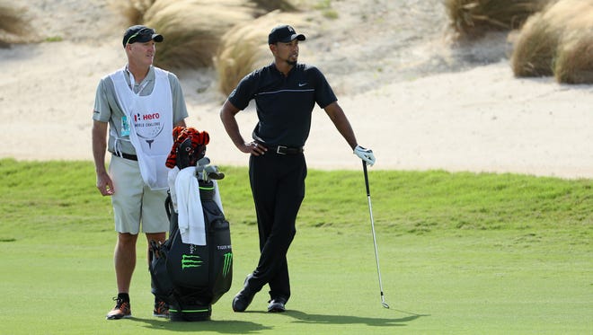 Tiger Woods waits to hit his second shot on the third hole alongside caddie Joe LaCava during Round 1 of the Hero World Challenge.