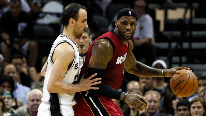 2014: LeBron James handles the ball against Ginobili during the first quarter in Game 1 of the NBA Finals.