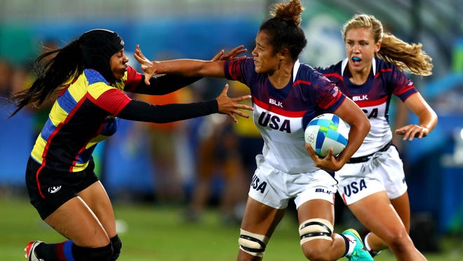 Colombia forward Isabel Cristina Romero Benitez (6) gets a hand to her face by USA forward Nana Faavesi (9) as Faavesi runs the ball during a rugby sevens match between the USA and Colombia at Deodoro Stadium in the Rio 2016 Summer Olympic Games.