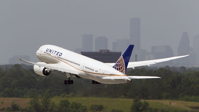 A United Boeing 787 Dreamliner takes off  within view of the Houston skyline. Houston Bush Intercontinental is United's second-busiest hub (by passengers).