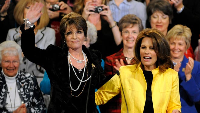 Palin waves to a rally crowd in Minneapolis with Michele Bachmann on April 7, 2010.