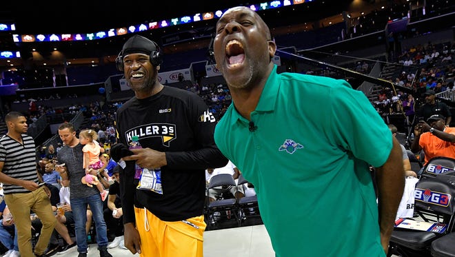 Coach Gary Payton of the 3 Headed Monsters jokes with Stephen Jackson #5 of the Killer 3s during week two of the BIG3 three on three basketball league at Spectrum Center on July 2, 2017 in Charlotte, North Carolina.