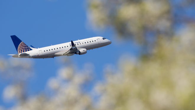 Fresh spring foliage bids farewell to a United Express Embraer E170 as it departs Chicago O'Hare International Airport in April 2016.