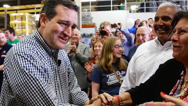 Cruz, left, shakes hands while campaigning in Omaha, Neb., on May 9, 2014, on behalf of Nebraska Republican Pete Ricketts in the governor's race.