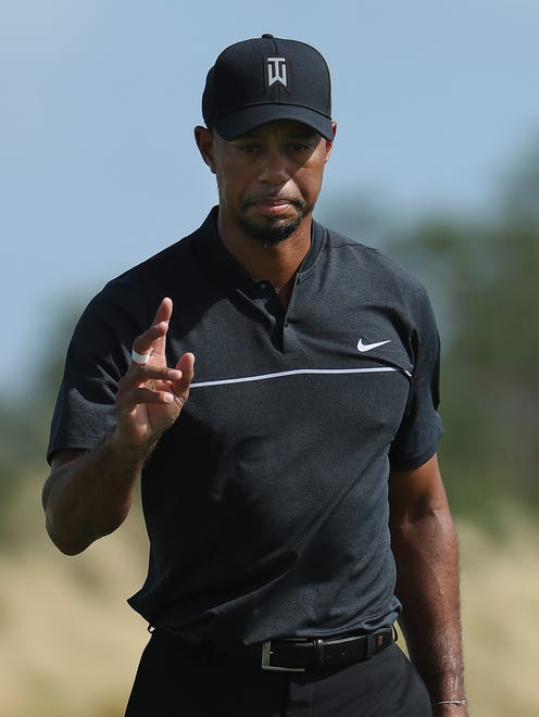 Tiger Woods his waves after putting on the second hole during Round 1 of the Hero World Challenge.