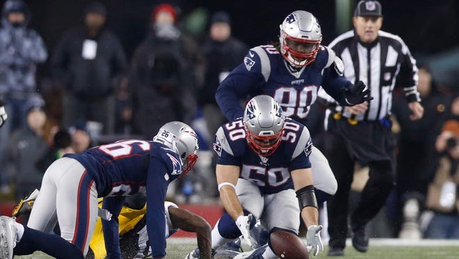 Patriots linebacker Rob Ninkovich (50) recovers a fumble against during the third quarter.