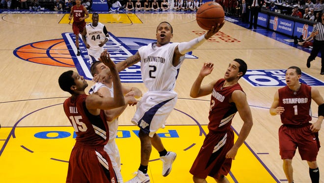 March 12, 2009: Thomas drives to the hoop past Stanford's Lawrence Hill and Landry Fields during the 2009 Pac-10 Men's Basketball Tournament.