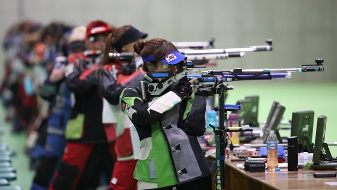 Shooters take aim during the 10-meter air rifle qualification at Olympic Shooting Centre.