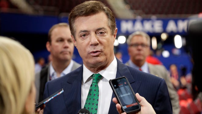 In this July 17, 2016 file photo, Paul Manafort talks to reporters on the floor of the Republican National Convention in Cleveland.
