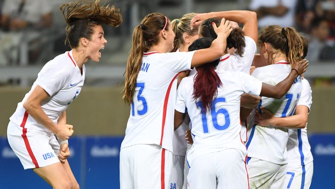 Team USA celebrates a goal by midfielder Carli Lloyd (10) over France during the first round match at Estadio Mineirao.