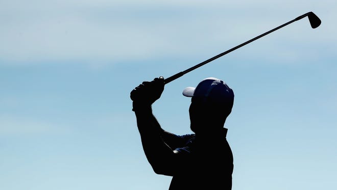 Tiger Woods hits a shot on the practice range before Round 2 of the Hero World Challenge.