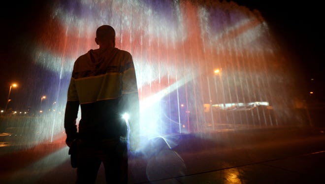 A man stands in front of a fountain illuminated with the colours of the United Kingdom flag in Zagreb,  Croatia during a tribute to victims of an attacks claimed by Islamic State which killed at least 22 people and left more than 60  injured in Manchester, May 23, 2017.