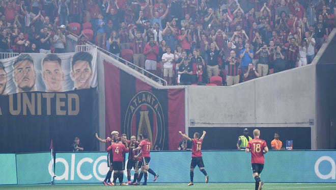 Atlanta United defender Leandro Gonzalez (5) celebrates his goal with teammates against the FC Dallas during the first half at Mercedes-Benz Stadium.