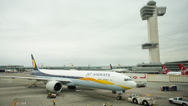 Ready for a long trip to India, a Jet Airways Boeing 777-300 is pushed back from the gate at New York's JFK Airport.