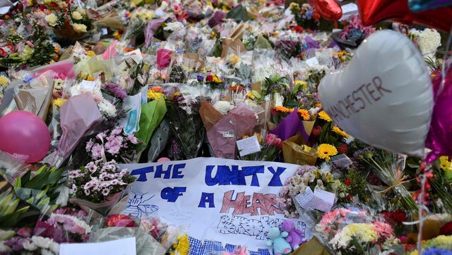 A carpet of flowers and messages lie at St Ann's Square in Manchester, northwest England on May 24, 2017, placed in tribute to the victims of the May 22 terror attack at the Manchester Arena.
