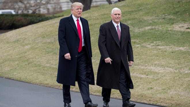 President Trump and Vice President Pence walk on the South Driveway of the White House to greet Harley Davidson executives and union representatives on Feb. 2, 2017.