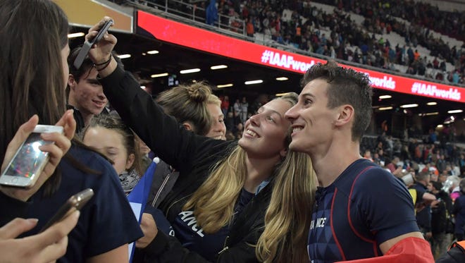 France's Pierre-Ambroise Bosse poses for a selfie with fans after winning the 800m during the IAAF World Championships.