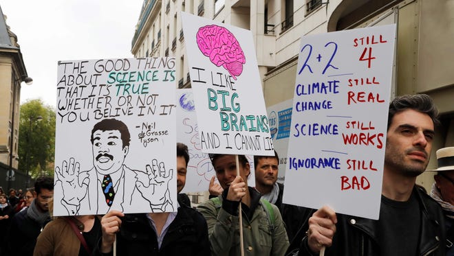 People take part in the March for Science  in Paris.