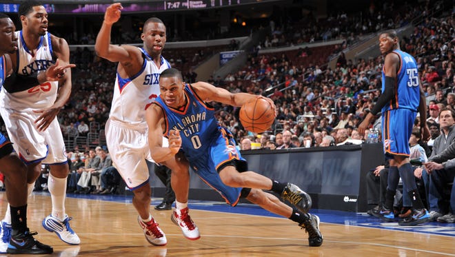 2010: Russell Westbrook of the Oklahoma City Thunder drives hard against Jodie Meeks of the Philadelphia 76ers.