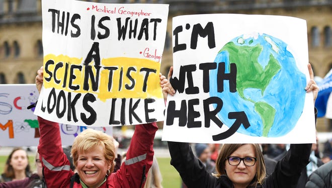 Stephanie Woodend, left, a PHD student in Medical Geography at the University of Ottawa and Abby Dalton, a masters student in Geography at the University of Ottawa, participate in the March for Science on Parliament Hill in Ottawa, Canada.