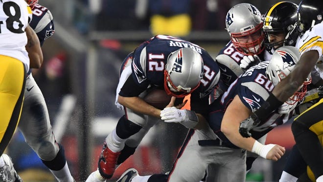 Patriots quarterback Tom Brady (12) runs the ball during the third quarter against the Steelers.