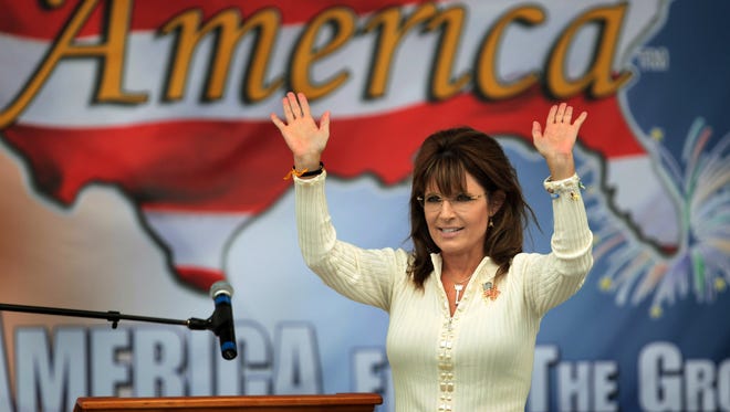Palin waves to the crowd as she arrives for the Tea Party's "Restoring America" event on Sept. 3, 2011, in Indianola, Iowa.