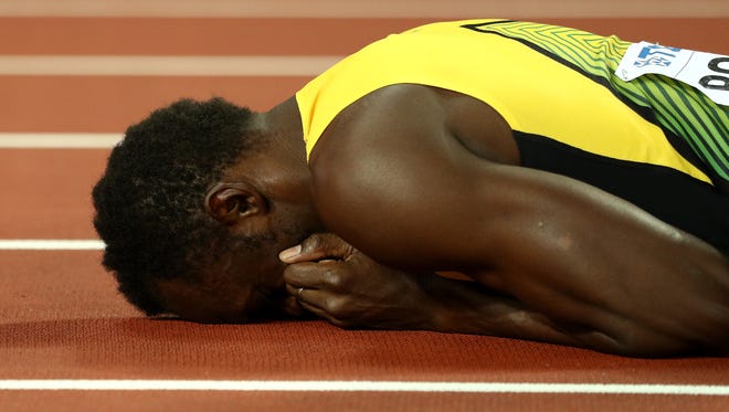 Usain Bolt of Jamaica falls to the track in the 4x100 relay final during day nine of the 16th IAAF World Athletics Championships at London Stadium.