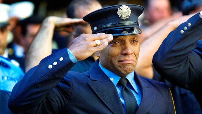 Firefighter Tony James cries while attending the funeral service for New York Fire Department Chaplain Rev. Mychal Judge on Sept. 15, 2001.