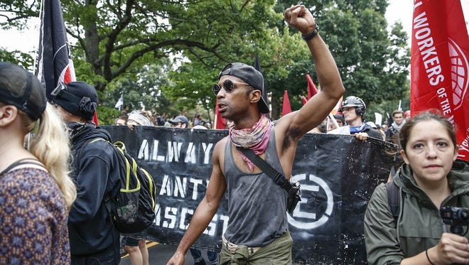 Counter protesters take to the street in front of Emancipation Park, formerly known as Lee Park, during the 'Unite the Right' rally in Charlottesville, Va., on Saturday, August 12, 2017.
