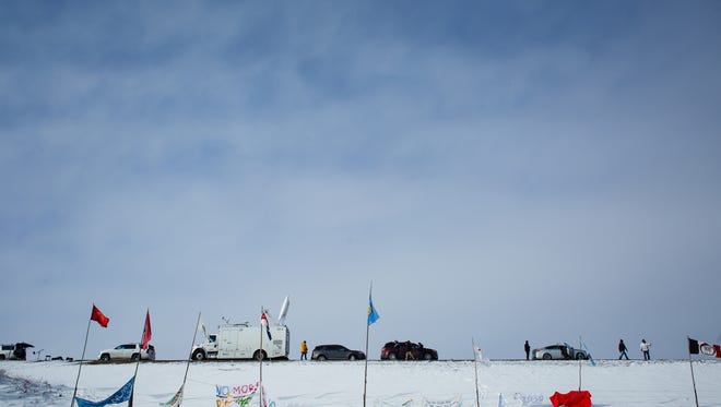 Cable news trucks line North Dakota State highway 1806 outside the Oceti Sakowin Camp near the Standing Rock Reservation on Saturday, Dec. 3, 2016 near Cannon Ball.