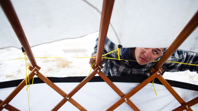 Rodney Wabashaw, 13 of Evans, CO, helps build a yurt paid for through a GoFundMe campaign put on by Indigenous Roots on Saturday, Dec. 3, 2016 near Cannon Ball. Wabashaw and his family, all originally from Sioux City, IA will be living in the yurt once it is finished.