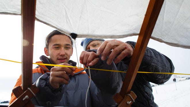 Cyler Wabashaw, 14 of Evans, CO, learns to tie a knot with the help of Heinz Brummel as they build a yurt paid for through a GoFundMe campaign put on by Indigenous Roots on Saturday, Dec. 3, 2016 near Cannon Ball. Wabashaw and his family, all originally from Sioux City, IA will be living in the yurt once it is finished.