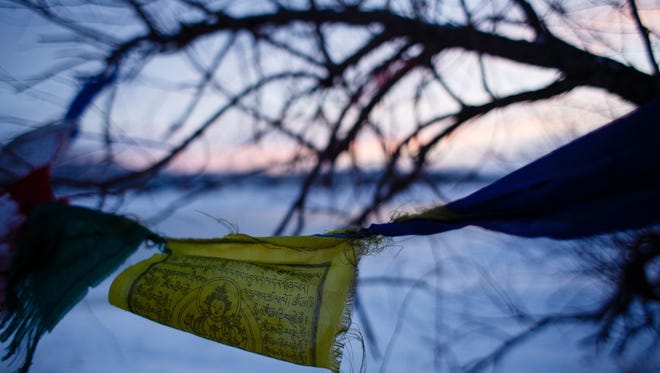 Prayer flags hang in the trees along the banks of the Cannonball River next to the Oceti Sakowin Camp near the Standing Rock Reservation on Saturday, Dec. 3, 2016 near Cannon Ball.