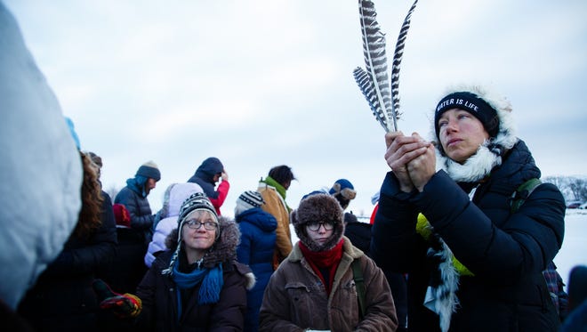 Tamara Sharp of Oakland, CA prays with other demonstrators at the Cannonball River during the morning prayer along the banks of the in the Oceti Sakowin Camp near the Standing Rock Reservation on Sunday, Dec. 4, 2016 in Cannon Ball.