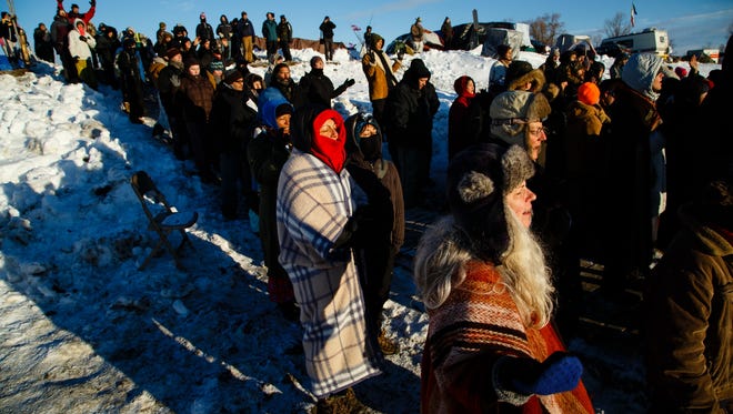 Demonstrators gather at the Cannonball River during the morning prayer in the Oceti Sakowin Camp near the Standing Rock Reservation on Sunday, Dec. 4, 2016 in Cannon Ball.