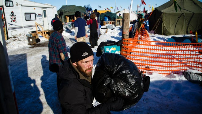 Mark Kruse of Duluth, MN helps load a truck with donations in the Oceti Sakowin Camp near the Standing Rock Reservation on Sunday, Dec. 4, 2016 near Cannon Ball. The donation tent where the items had been stored needs to be converted to housing so the donations had to be moved.