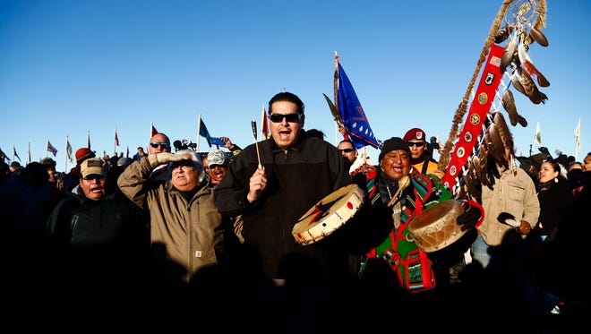 Tribal leaders walk into the drum circle at the Oceti Sakowin Camp after the Army Corps of Engineers denied an easement to cross the Missouri River on Sunday, Dec. 4, 2016 near Cannon Ball.