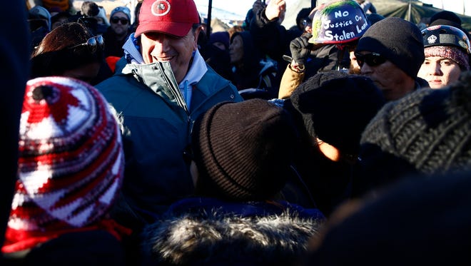 Standing Rock Sioux Tribal Council Chairman, Dave Archambault II greets demonstrators as they celebrate after the Army Corps of Engineers denied Dakota Access an easement to cross the Missouri River on Sunday, Dec. 4, 2016 near Cannon Ball.