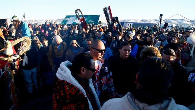 Native's play in a drum circle at the Oceti Sakowin Camp after the Army Corps of Engineers denied Dakota Access an easement to cross the Missouri River on Sunday, Dec. 4, 2016 near Cannon Ball.