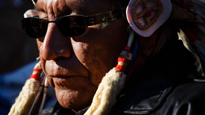 Chief Arvol Looking Horse, listens as speakers address the crowd in the Oceti Sakowin Camp near the Standing Rock Reservation on Sunday, Dec. 4, 2016 near Cannon Ball.
