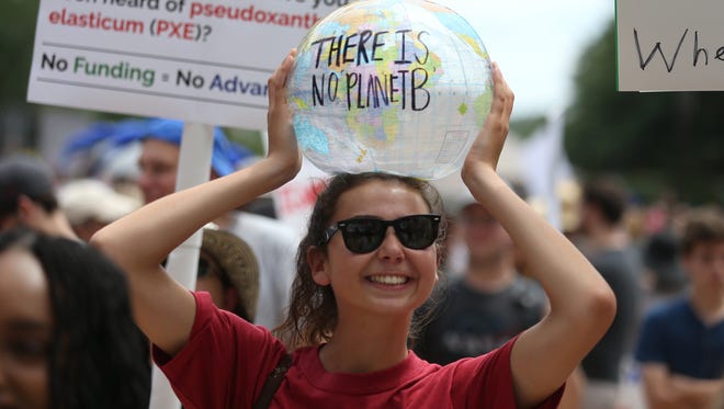 Coryn Cannon joins thousands of people gathering together at the Historic Capitol building downtown Tallahassee, Fla.for the March for Science, part of a world-wide demonstration on Earth Day to promote the idea of scientific study and its relevance in society.