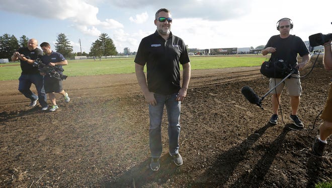 Tony Stewart takes in the temporary 3/16th dirt oval made for him inside Turn 3 at Indianapolis Motor Speedway.