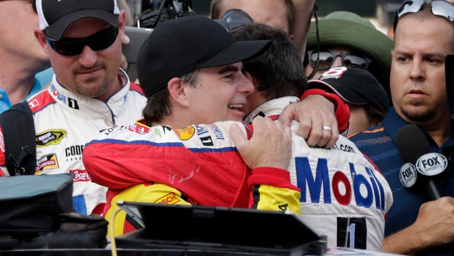 Stewart gets a hug from Jeff Gordon after the Brickyard 400 on July 24, 2016. Gordon came out of retirement for the race and filled in for Dale Earnhardt Jr.