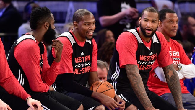 2015: Western Conference guard James Harden of the Houston Rockets (13, left), forward Kevin Durant of the Oklahoma City Thunder (35, center), and center DeMarcus Cousins of the Sacramento Kings (15, right) talk during practice at Madison Square Garden.