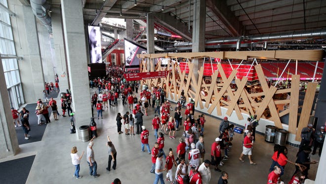 Fans walk through a concourse before the Atlanta Falcons' game against the Arizona Cardinals at new Mercedes-Benz Stadium.