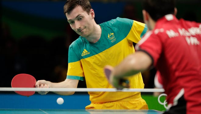 David Powell of Australia returns the ball as he plays Marcelo Aguirre of Paraguay during the table tennis singles preliminary round at Riocentro.
