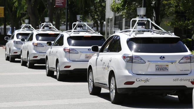 A row of Google self-driving cars outside the Computer History Museum in Mountain View, Calif. , in 2014