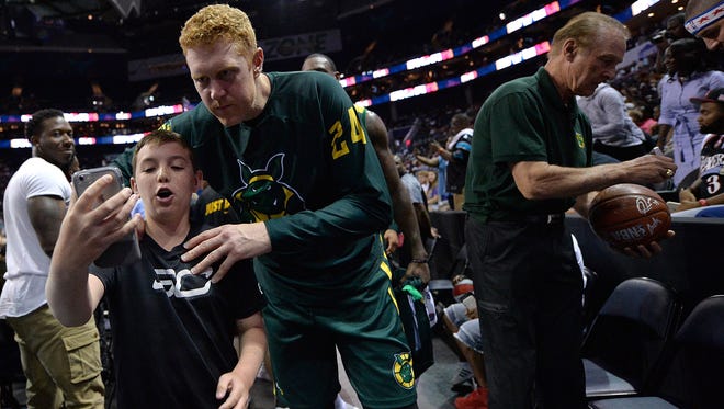 Brian Scalabrine #24 of Ball Hogs poses for a photo with a young fan after a win over Tri-State during week two of the BIG3 three on three basketball league at Spectrum Center on July 2, 2017 in Charlotte, North Carolina.