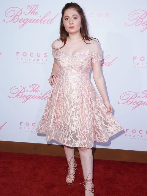Actor Emma Kenney wore a pale pink, off-the-shoulder dress with strappy, tie-up heels.