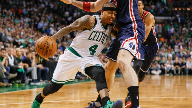 Boston Celtics point guard Isaiah Thomas (4) drives into Washington Wizards center Marcin Gortat (13) during the fourth quarter in Game 2.